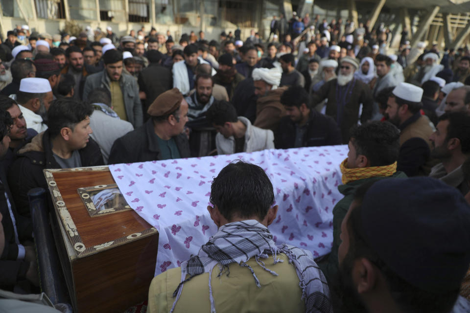 CORRECTS DATE OF ATTACK AND IDENTIFIES RASHEED AS THE HEAD OF THE INDEPENDENT ELECTIONS WATCHDOG -- Afghans carry the coffin of Mohammad Yousuf Rasheed, executive director of the non-governmental Free and Fair Election Forum of Afghanistan, during his funeral ceremony, in Kabul, Afghanistan, Wednesday, Dec. 23, 2020. Separate bombing and shooting attacks in Afghanistan’s capital left several people dead Wednesday, including Rasheed, the head of the independent elections watchdog, officials said. (AP Photo/Rahmat Gul)