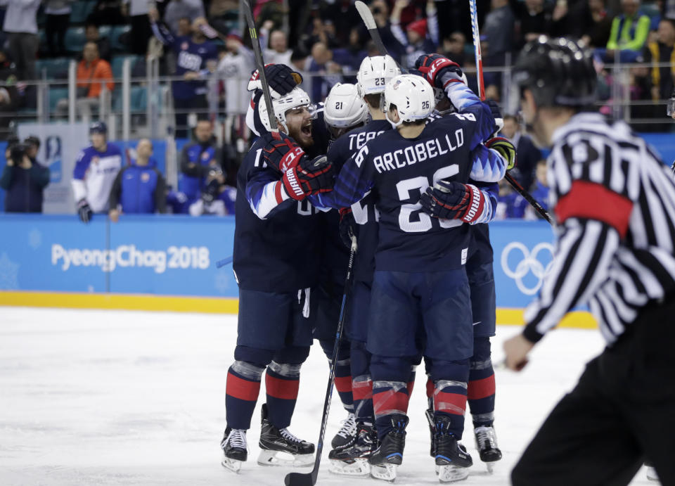 Players from the United States celebrate after Ryan Donato scores a goal against Slovakia during the third period of the preliminary round of the men’s hockey game at the 2018 Winter Olympics. (AP)