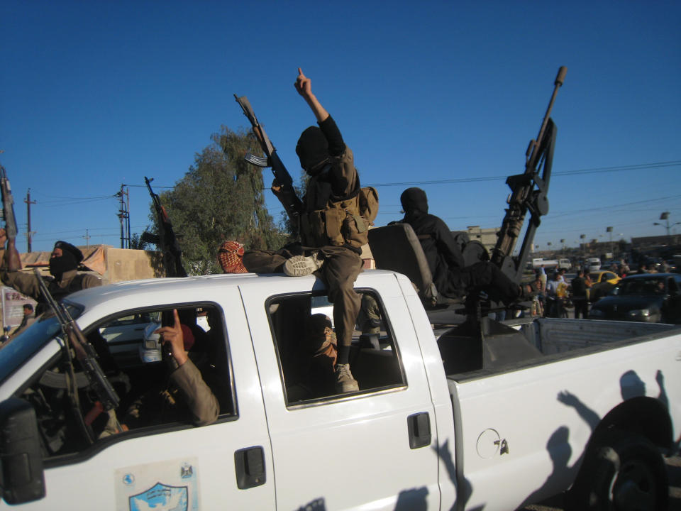 FILE - In this file photo taken on March 20, 2014, al-Qaida fighters patrol in a commandeered Iraqi security forces truck in Fallujah, Iraq. Iraqi military officials are warning that efforts to clear militants from Fallujah and parts of nearby Ramadi are proving much more difficult than they anticipated when the jihadists showed up three months ago. That realization, as they acknowledged during a recent tour of special forces operations, casts doubt on Iraq's ability to hold elections in Fallujah next month. (AP Photo, File)