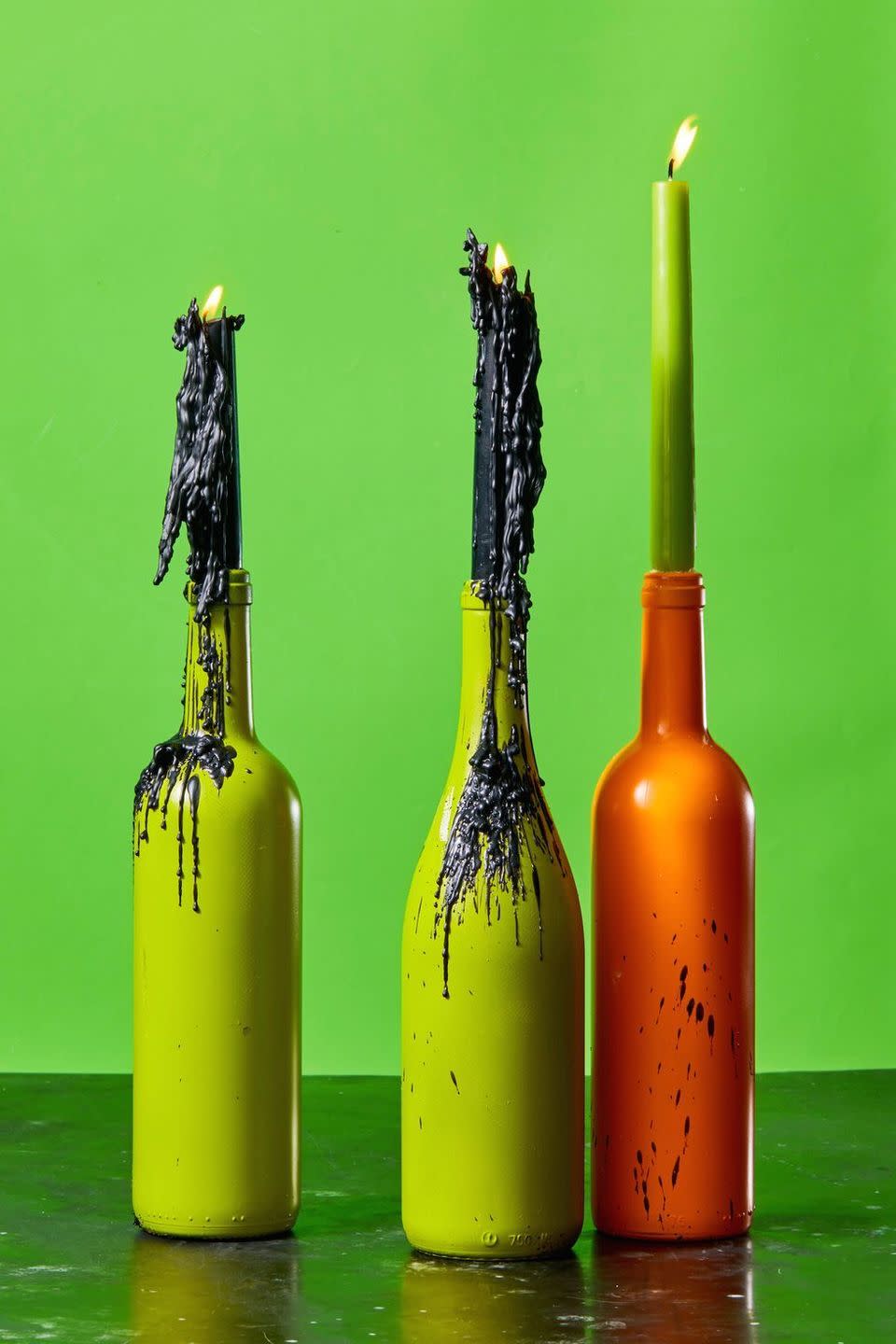 <p>Make basic candlesticks just a little bit creepy for a standout centerpiece. Start by spray painting old wine bottles in orange and green and filling them with candlesticks. You can even let wax drip to make more of an impact. <br></p><p><a class="link " href="https://go.redirectingat.com?id=74968X1596630&url=https%3A%2F%2Fwww.etsy.com%2Flisting%2F711505565%2Fgreen-4-chime-candles-set-of-10-spell&sref=https%3A%2F%2Fwww.goodhousekeeping.com%2Fholidays%2Fhalloween-ideas%2Fg33437890%2Fhalloween-table-decorations-centerpieces%2F" rel="nofollow noopener" target="_blank" data-ylk="slk:SHOP CANDLESTICKS;elm:context_link;itc:0;sec:content-canvas">SHOP CANDLESTICKS</a></p>