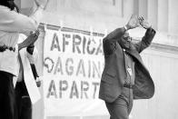 FILE - Desmond Tutu greets a crowd of 10,000 people with his hands held high during a rally at the Greek Theater on the University of California at Berkeley, Calif., campus, May 14, 1985. Tutu praised the students for their opposition to apartheid in South Africa. (AP Photo/Eric Risberg, File)