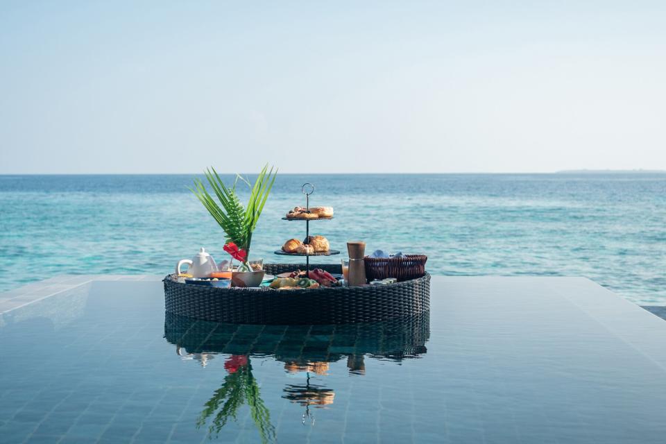 Floating breakfast on infinity pool in luxury hotel in the Maldives