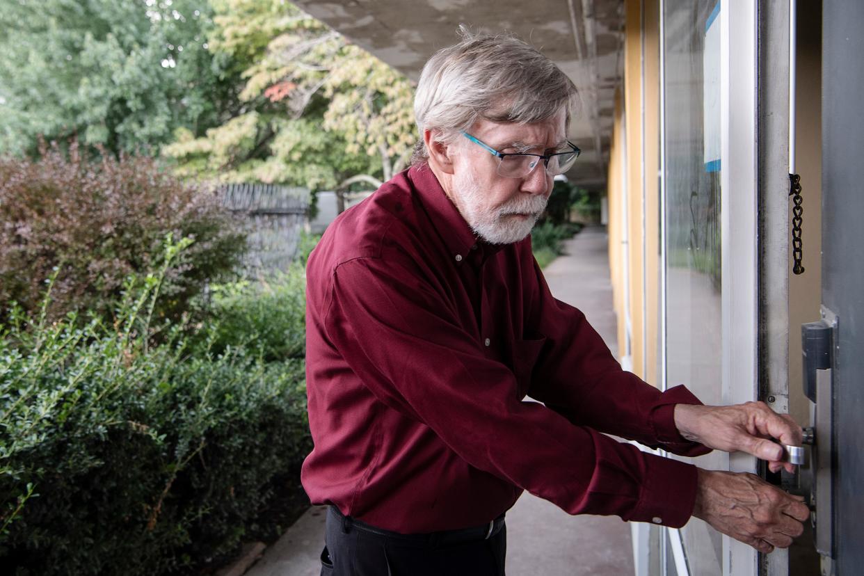 Jim Lowder, capital campaign manager for Homeward Bound's Home is Key initiative, opens the door to one of the hotel rooms that will house members of Asheville's chronically homeless population.