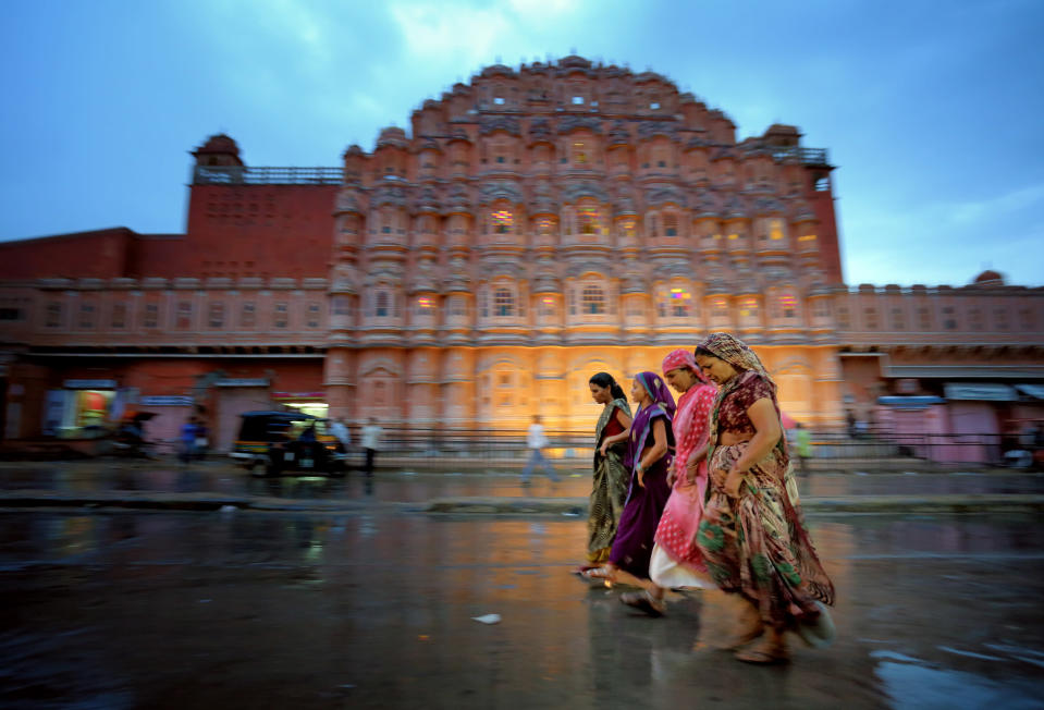 I thought this would be a good place for pictures, so I returned during the evening on my second night in Jaipur. I got lucky with the rain because it made for interesting reflections, and I had a good time trying to capture the chaotic motion on the streets of Jaipur. Hawa Mahal (The Palace of Winds) is pictured in the background. (Photo and caption by Edward Graham/National Geographic Traveler Photo Contest) <br> <a href="http://travel.nationalgeographic.com/travel/traveler-magazine/photo-contest/2013/" rel="nofollow noopener" target="_blank" data-ylk="slk:See more and submit;elm:context_link;itc:0;sec:content-canvas" class="link ">See more and submit</a>