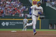 Texas Rangers center fielder Joey Gallo (13) rounds the bases after hitting a home run against the Seattle Mariners in the second inning of a baseball game Saturday, May 8, 2021, in Arlington, Texas. (AP Photo/Louis DeLuca)