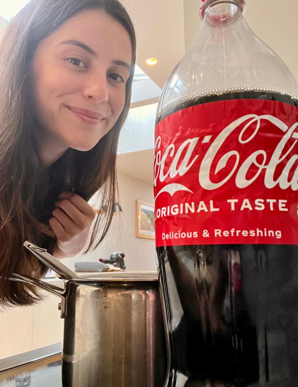 The author taking a selfie with the bottle of Coca-Cola.