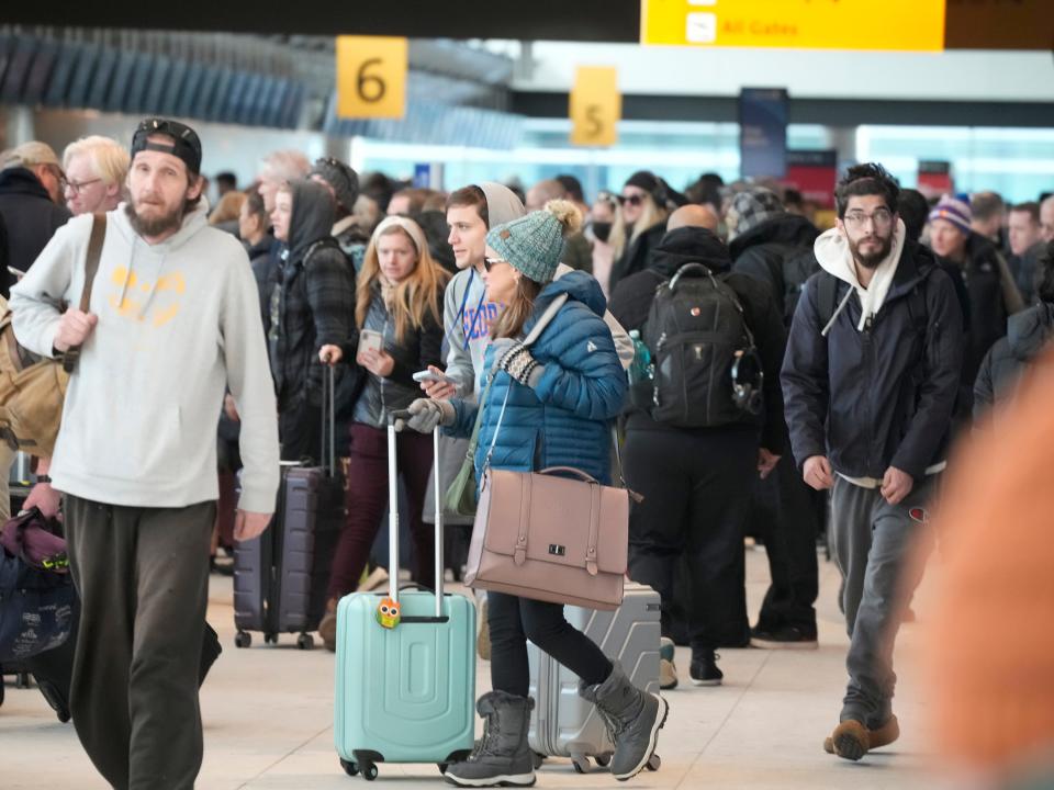 Travelers queue up to check in at the Southwest Airlines counter in Denver International Airport after a winter storm swept over the country packing snow combined with Arctic cold, which created chaos for people trying to reach their destinations before the Christmas holiday, Friday, Dec. 23, 2022, in Denver.