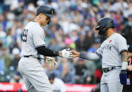 New York Yankees' Aaron Judge celebrates after his two-run home run against the Seattle Mariners with Gleyber Torres during the third inning of a baseball game Monday, May 29, 2023, in Seattle. (AP Photo/Lindsey Wasson)