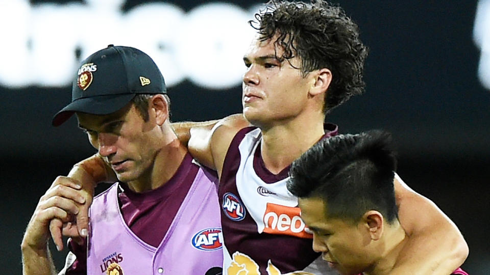 Lions star Cam Rayner leaves the field injured during the AFL Community Series match against the Gold Coast Suns. (Photo by Matt Roberts/AFL Photos/via Getty Images)