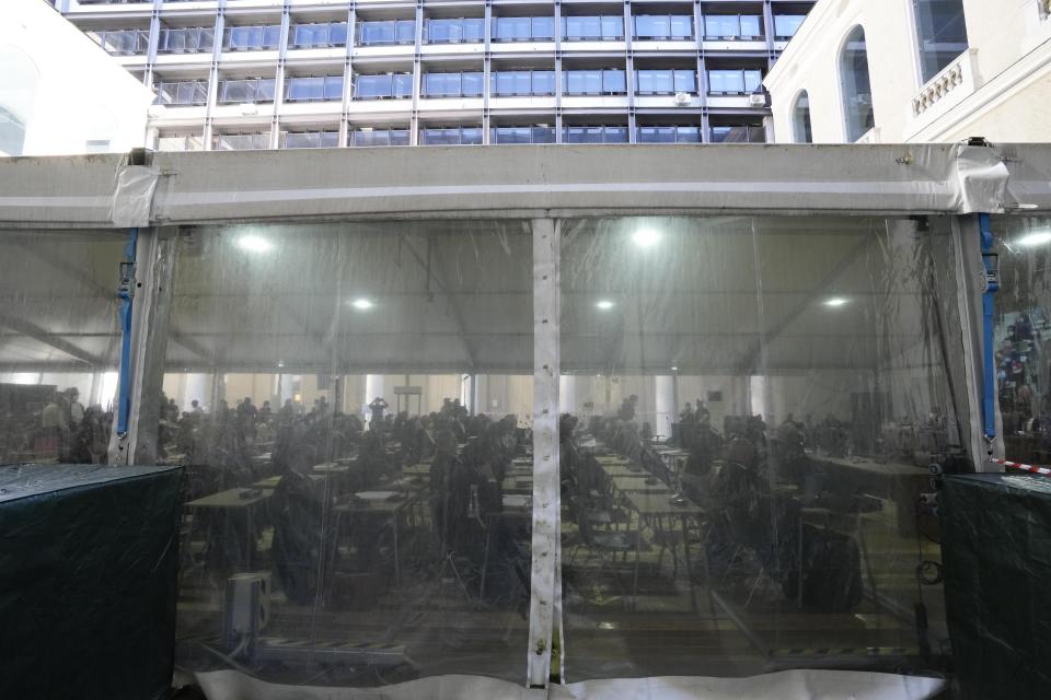 Lawyers attend the first hearing of the trial for the Morandi bridge collapse at the Genoa's Palace of Justice Thursday, July 7, 2022. Forty-three people were killed when a large stretch of the Morandi Bridge broke off, August 14, 2018, on the eve of one of Italy's biggest vacation holidays. (AP Photo/Antonio Calanni)