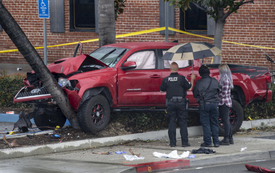 Fullerton Police investigate an early-morning accident that injured several pedestrians, Sunday, Feb. 10, 2019, in Fullerton, Calif. Authorities say a suspected drunken driver was arrested after his pickup truck plowed into a crowd on a sidewalk, injuring multiple people, including some victims who were trapped under the vehicle. (Mindy Schauer/The Orange County Register via AP)