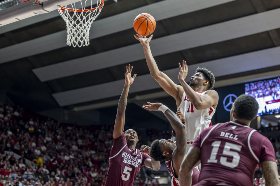 Alabama forward Mohamed Wague (11) scores two over Mississippi State guard Shawn Jones Jr. (5) and forward D.J. Jeffries (0) during the first half of an NCAA college basketball game, Saturday, Feb. 3, 2024, in Tuscaloosa, Ala. (AP Photo/Vasha Hunt)