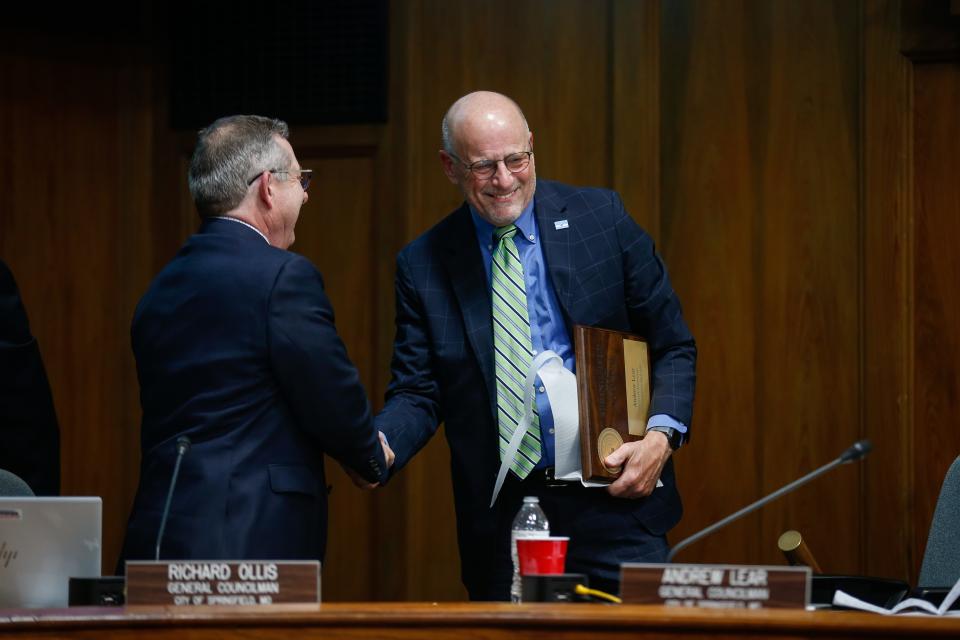 Former City Council General Seat Councilmen Andrew Lear, right, and Richard Ollis shake hands after Lear's closing remarks during the Springfield City Council meeting on Monday, April 17, 2023.