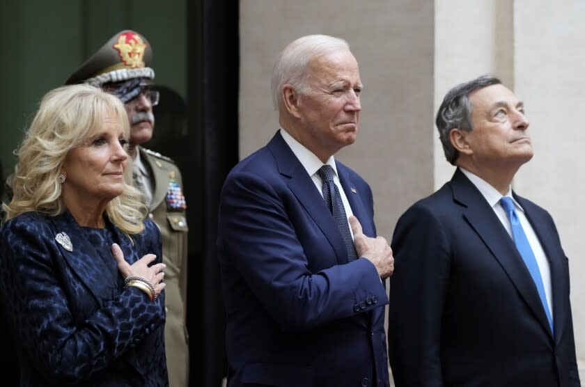 U.S. President Joe Biden, center, and first lady Jill Biden, left, take part in a ceremony with Italy's Prime Minister Mario Draghi at the Chigi Palace in Rome, Friday, Oct. 29, 2021. A Group of 20 summit scheduled for this weekend in Rome is the first in-person gathering of leaders of the world's biggest economies since the COVID-19 pandemic started. (AP Photo/Gregorio Borgia)