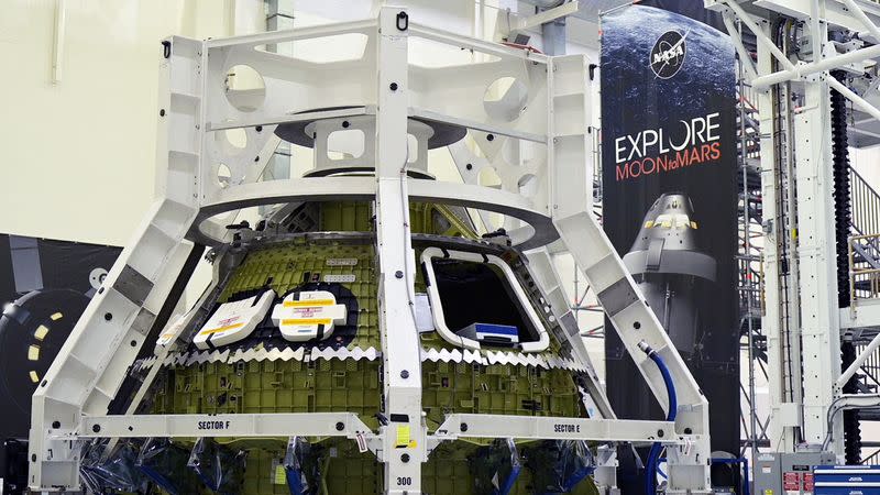 NASA's Orion crew module for the Artemis 3 mission stands in the Operations and Checkout Building during a media tour at Cape Canaveral