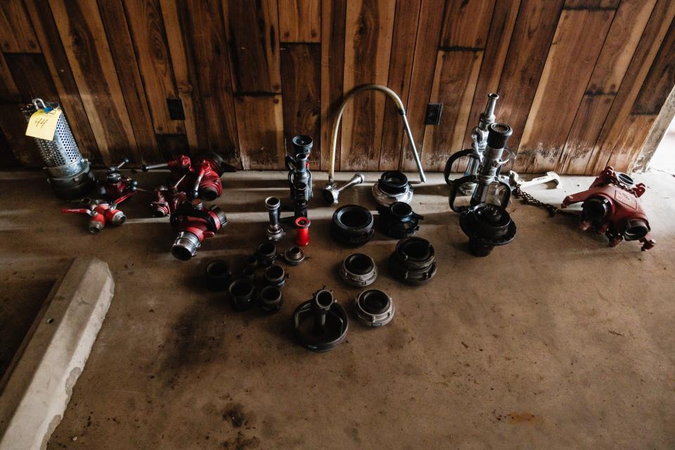 Various fire hose fittings are seen among items up for auction in the fire station formerly run by the Newcomerstown Emergency Rescue Squad, Inc., in Newcomerstown.