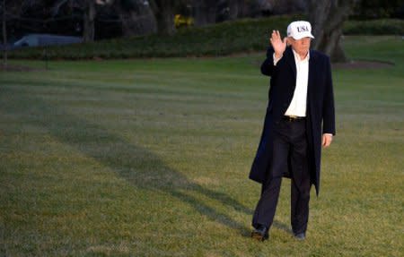 U.S. President Donald Trump casts a shadow as he waves and approaches the press to make remarks as he returns from a weekend at the presidential retreat at Camp David to the White House, Washington, U.S., December17, 2017.           REUTERS/Mike Theiler