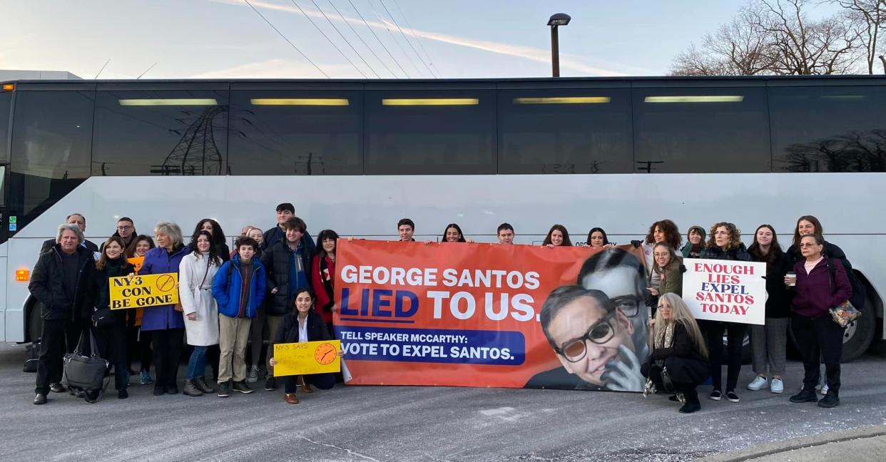 Members of the ‘Concerned Citizens of NY-03’ group reveal a banner slamming George Santos (Concerned Citizens of NY-03)