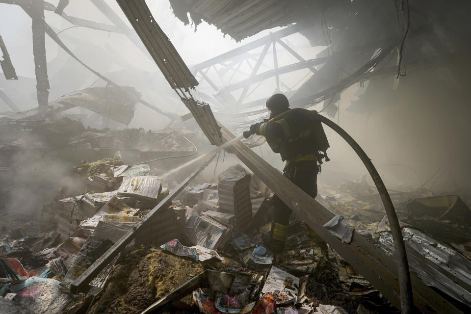 Firefighters put out a fire after a Russian missile hit a large printing house in Kharkiv, Ukraine, Thursday, May 23, 2024. Russian missiles slammed into Ukraine’s second-largest city in the northeast of the country and killed at least seven civilians early Thursday, officials said, as Kyiv’s army labored to hold off an intense cross-border offensive by the Kremlin’s larger and better-equipped forces. (AP Photo/Andrii Marienko)