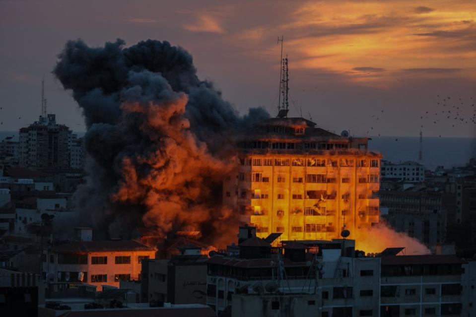 Plumes of smoke fill the sky as a result of Israeli airstrikes in Gaza City on Oct. 7.<span class="copyright">Saher Alghorra—Middle East Images/AFP/Getty Images</span>