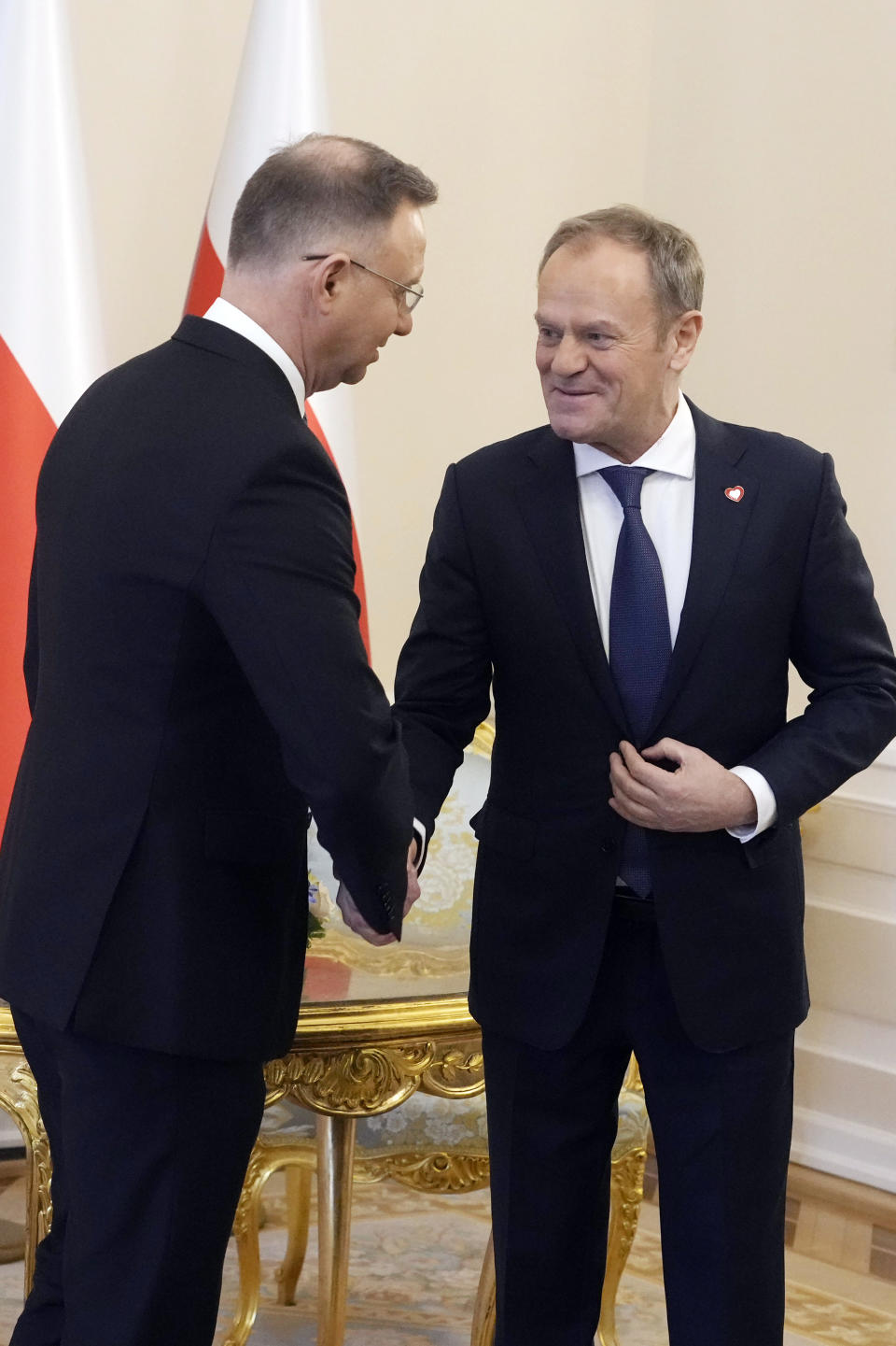 Poland's President Andrzej Duda, left, who is allied with the right-wing opposition, and new pro-European Union Prime Minister Donald Tusk shake hands before talks on Poland's security and continuing support for neighbouring Ukraine, at the Presidential Palace in Warsaw, Poland, Monday Jan. 15, 2024. Tusk is to travel to Kyiv in the coming days at the invitation of Ukraine President Volodymyr Zelenskyy. (AP Photo/Czarek Sokolowski)