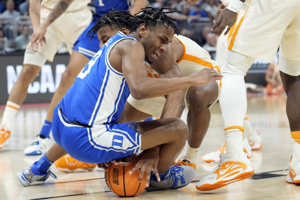 Duke guard Jeremy Roach (3) and Tennessee guard Josiah-Jordan James (30) battle for a loose ball during the first half of a second-round college basketball game in the NCAA Tournament Saturday, March 18, 2023, in Orlando, Fla. (AP Photo/Chris O'Meara)