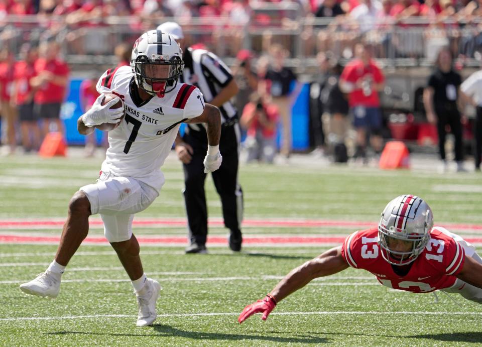 September 10, 2022; Columbus, Ohio, USA; Arkansas State Red Wolves wide receiver Champ Flemings (7) dodges Ohio State Buckeyes safety Cameron Martinez (13) during the first half of Saturday's game at Ohio Stadium.Mandatory Credit: Barbara J. Perenic/Columbus Dispatch