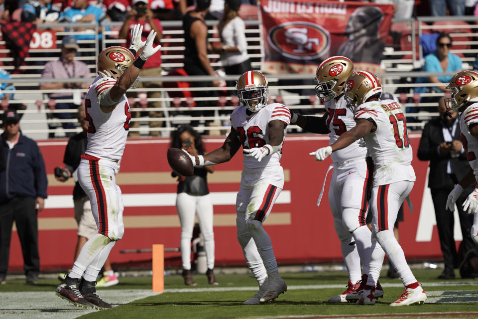 San Francisco 49ers running back Tevin Coleman celebrates and is greeted by his teammates after scoring a touchdown during the first half of an NFL football game against the Carolina Panthers in Santa Clara, Calif., Sunday, Oct. 27, 2019. The touchdown was Coleman's third in the first half. (AP Photo/Tony Avelar)