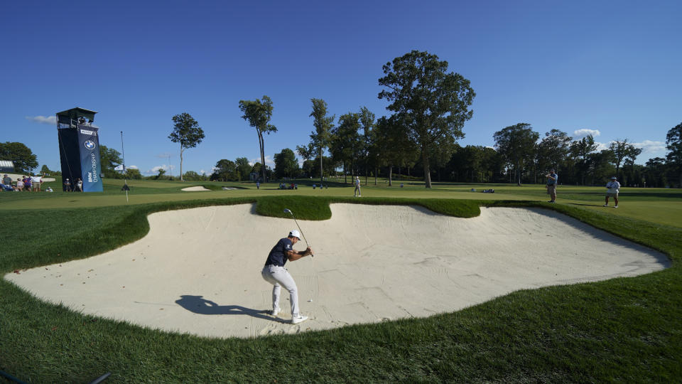 Viktor Hovland, of Norway, hits out of the bunker on the 14th green during the first round of the BMW Championship golf tournament at Wilmington Country Club, Thursday, Aug. 18, 2022, in Wilmington, Del. (AP Photo/Julio Cortez)