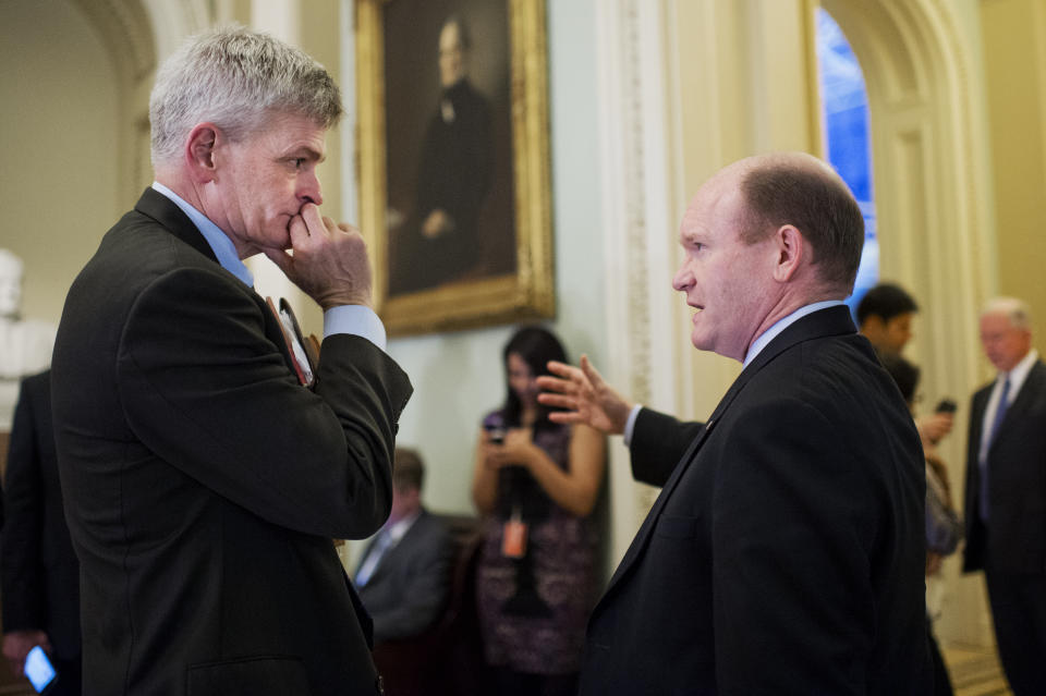 Sens. Bill Cassidy, R-La., left, and Chris Coons, D-Del., talk before the Senate Policy luncheons in the Capitol, December 15, 2015. (Photo By Tom Williams/CQ Roll Call)