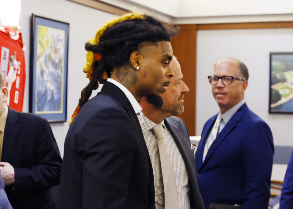 Former NFL cornerback Damon Arnette, foreground, arrives for his arraignment with attorney Ross Goodman at the Regional Justice Center, Wednesday, May 24, 2023, in Las Vegas. Arnette pleaded not guilty to felony charges alleging that he brandished a handgun during an argument with Las Vegas Strip casino valets in January 2022, and his lawyer is challenging his indictment. (Bizuayehu Tesfaye/Las Vegas Review-Journal via AP)