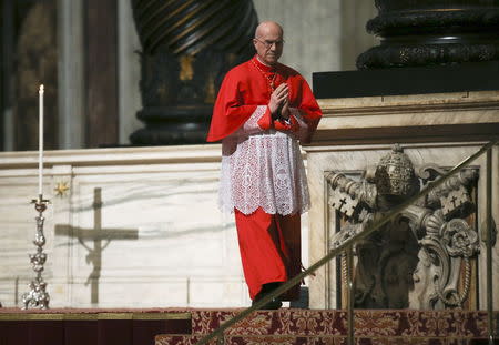 Cardinal Tarcisio Bertone walks during the Celebration of the Lord's Passion in Saint Peter's Basilica at the Vatican, March 25, 2016. REUTERS/Alessandro Bianchi