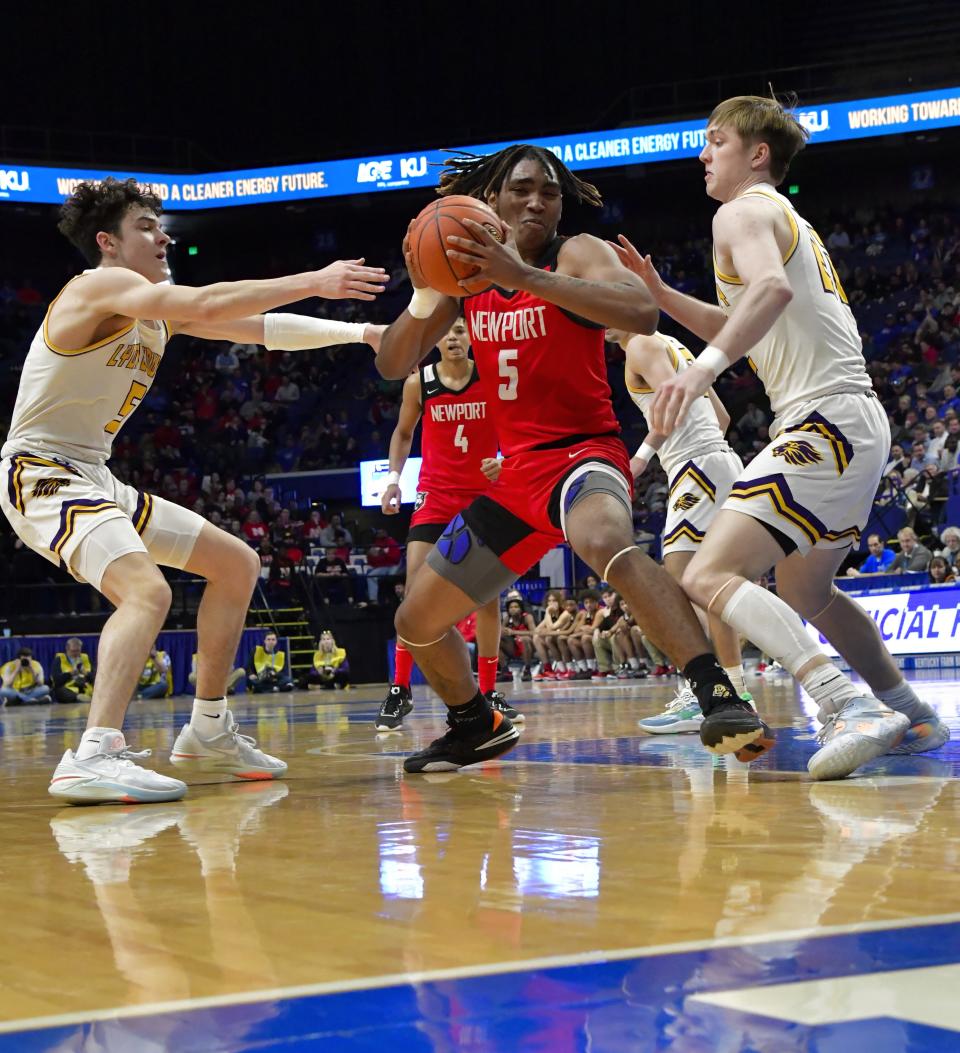 Marquez Miller (5) power his way to the hoop for Newport at the KHSAA Sweet 16 state basketball tournament, March 16, 2023.