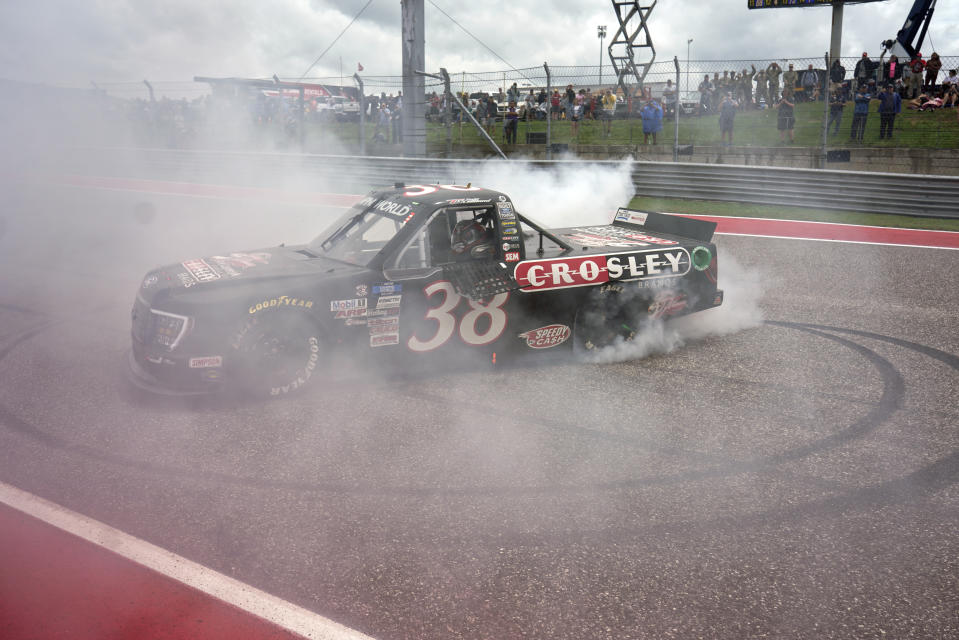 Todd Gilliland performs a burnout after winning the NASCAR Truck Series auto race at the Circuit of the Americas in Austin, Texas, Saturday, May 22, 2021. (AP Photo/Chuck Burton)