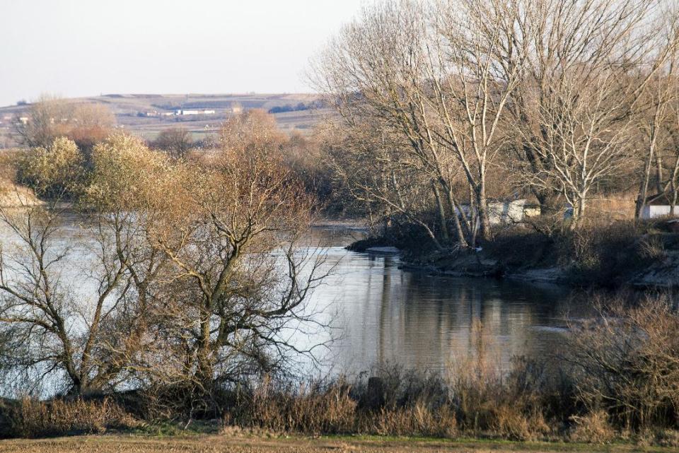 In this photo taken on Sunday, Dec. 4, 2016, the river Evros is seen from a spot near the Greek town of Didymoteicho, at the Greek-Turkish border. A year after the uncontrolled influx of more than a million refugees and economic migrants to debt-hobbled Greece, en route to Europe's prosperous heartland, this border region is again seeing rising migratory flows. (AP Photo/Giannis Papanikos)