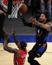 New York Knicks guard Derrick Rose, right, drives to the basket past New Orleans Pelicans guard Eric Bledsoe, left, during overtime of an NBA basketball game Sunday, April 18, 2021, in New York. (AP Photo/Adam Hunger, Pool)