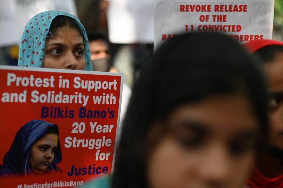 Demonstrators hold placards during a protest against the release of men convicted of gang-raping of Bilkis Bano during the 2002 communal riots in Gujarat, in  New Delhi on 27 August 2022 (AFP via Getty Images)