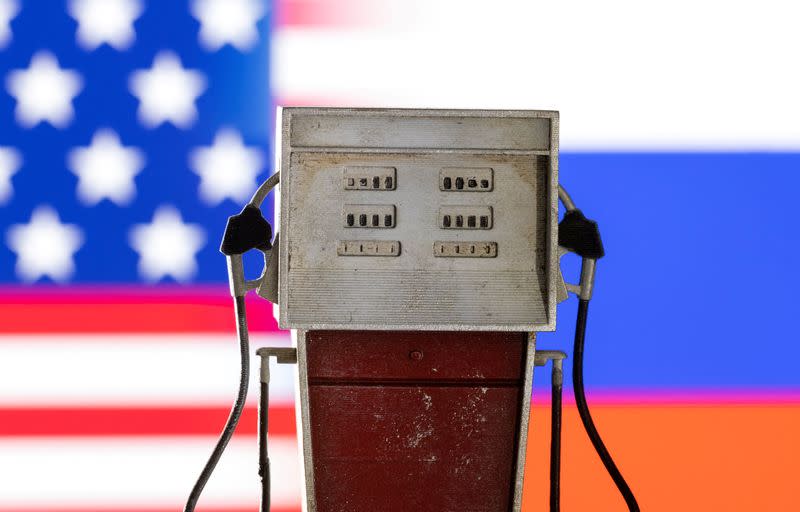 FILE PHOTO: Illustration shows model of petrol pump, U.S. and Russian flag colors