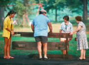 <p>Family salvages picnic table, unidentified Park. (Photograph by Ed Hausner/NYC Parks Photo Archive/Caters News) </p>