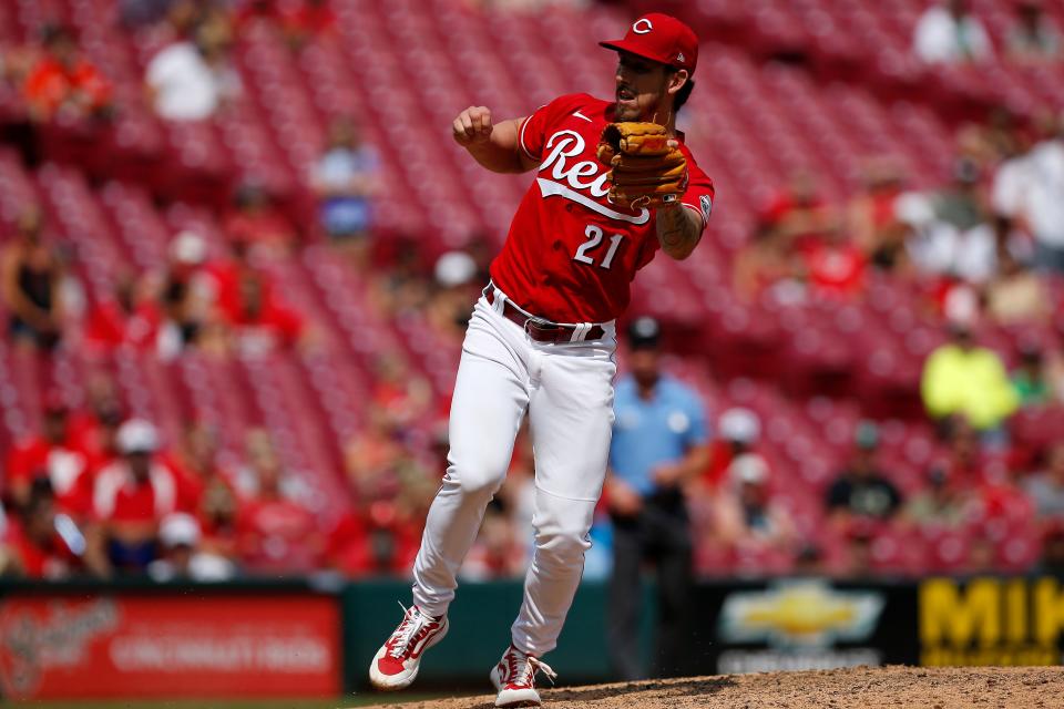 Cincinnati Reds relief pitcher Michael Lorenzen (21) snags a come-back bouncing ground ball off the bat of Miami Marlins second baseman Jazz Chisholm Jr. (2) in the ninth inning of the MLB National League game between the Cincinnati Reds and the Miami Marlins at Great American Ball Park in downtown Cincinnati on Sunday, Aug. 22, 2021. The Reds took the lead and won, 3-1, on two solo home runs from Mike Moustakas and Tyler Naquin.