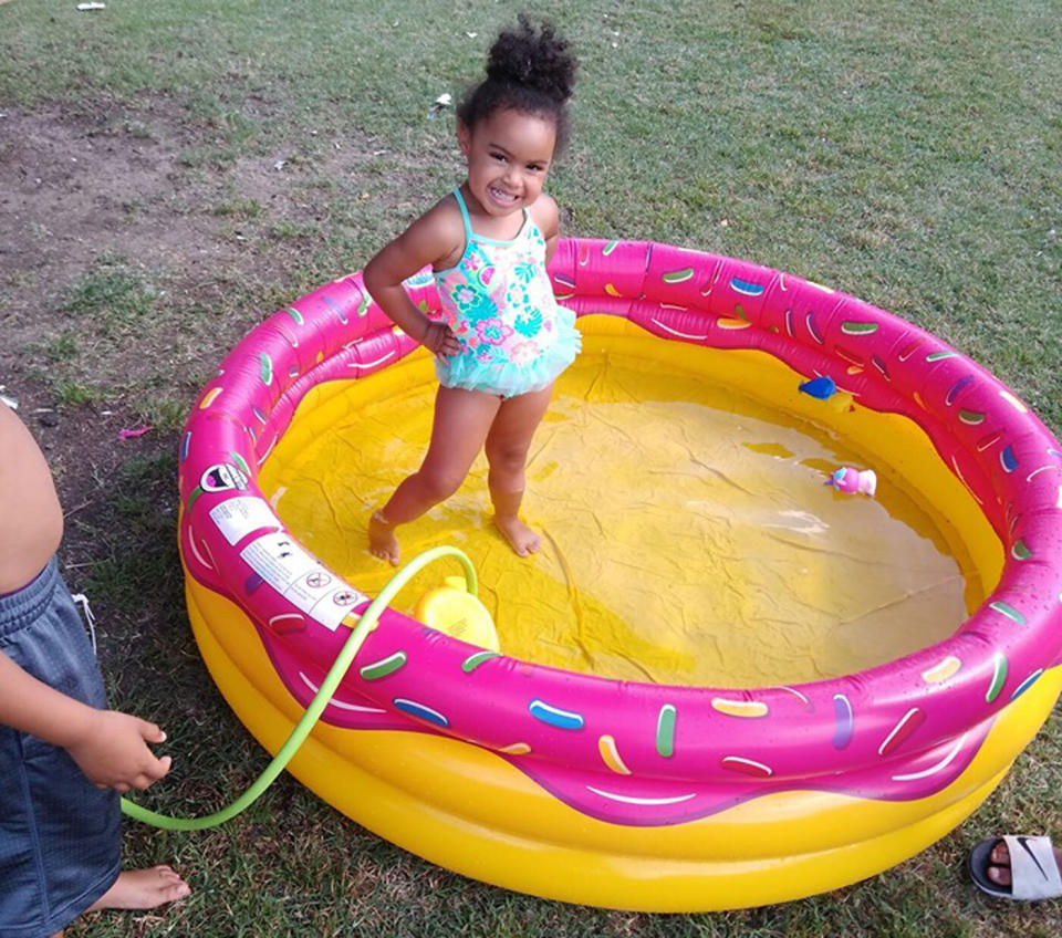 The little girl enjoying the inflatable pool the Wichita police officers bought for her. Source: Facebook/ Danielle Hutton