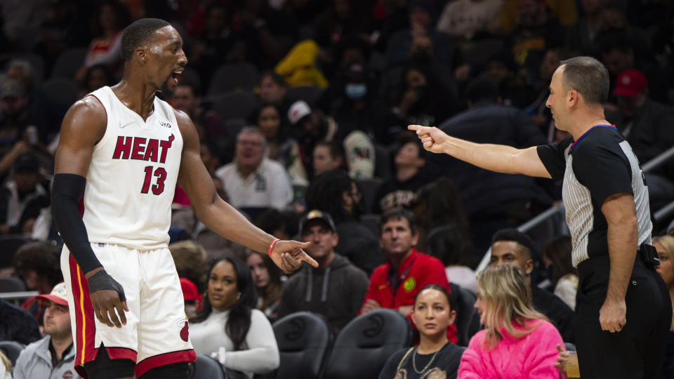 Referee Kane Fitzgerald, right, points to Miami Heat center Bam Adebayo (13) during the second half of an NBA basketball game against the Atlanta Hawks, Friday, Jan. 21, 2022, in Atlanta. (AP Photo/Hakim Wright Sr.)