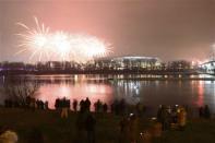 Fireworks explode next to the National Stadium during New Year celebrations in Warsaw January 1, 2014. REUTERS/Franciszek Mazur/Agencja Gazeta