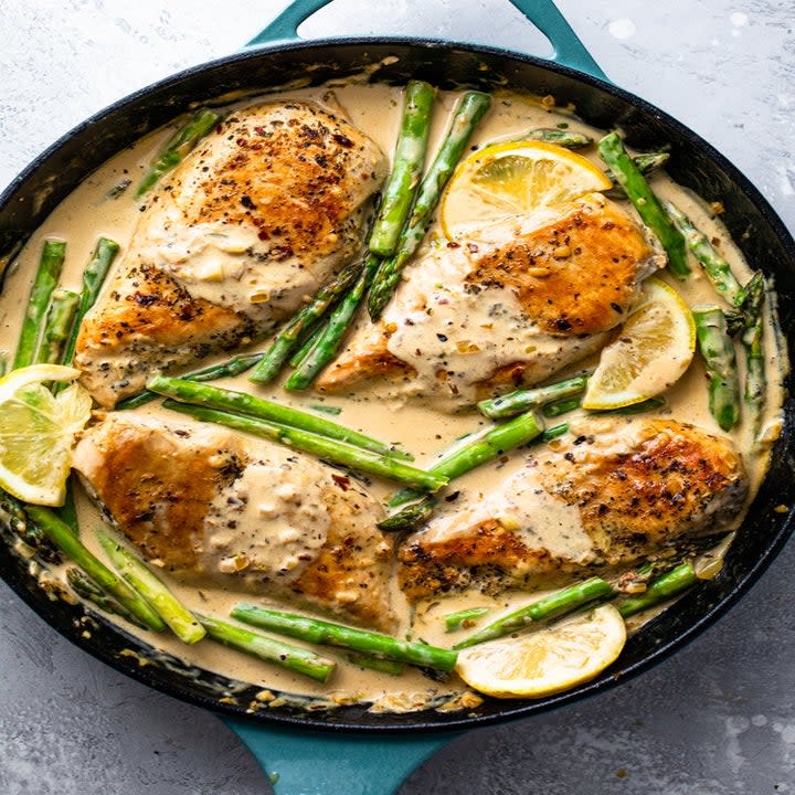 Skillet lemon chicken in cream sauce with asparagus.