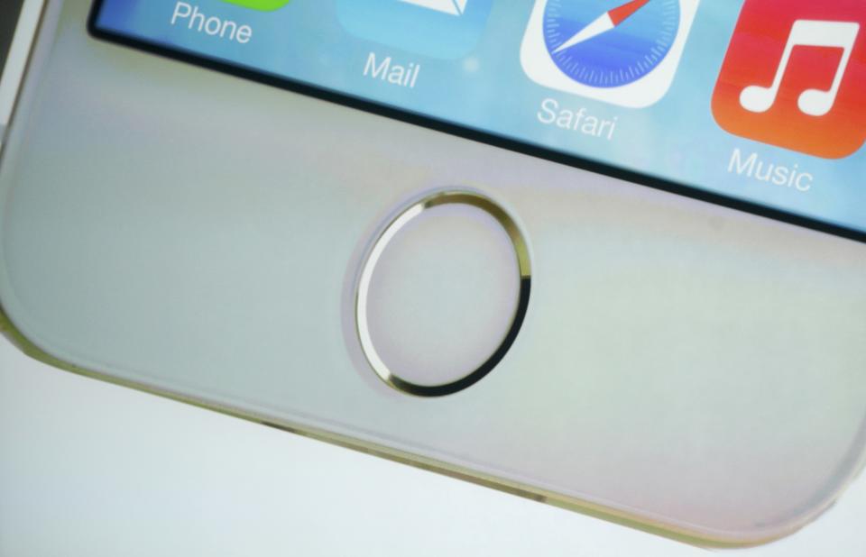 The home button which doubles as a fingerprint sensor is seen on an image of the new iPhone 5S at Apple Inc's media event in Cupertino, California September 10, 2013. REUTERS/Stephen Lam (UNITED STATES - Tags: BUSINESS SCIENCE TECHNOLOGY BUSINESS TELECOMS)