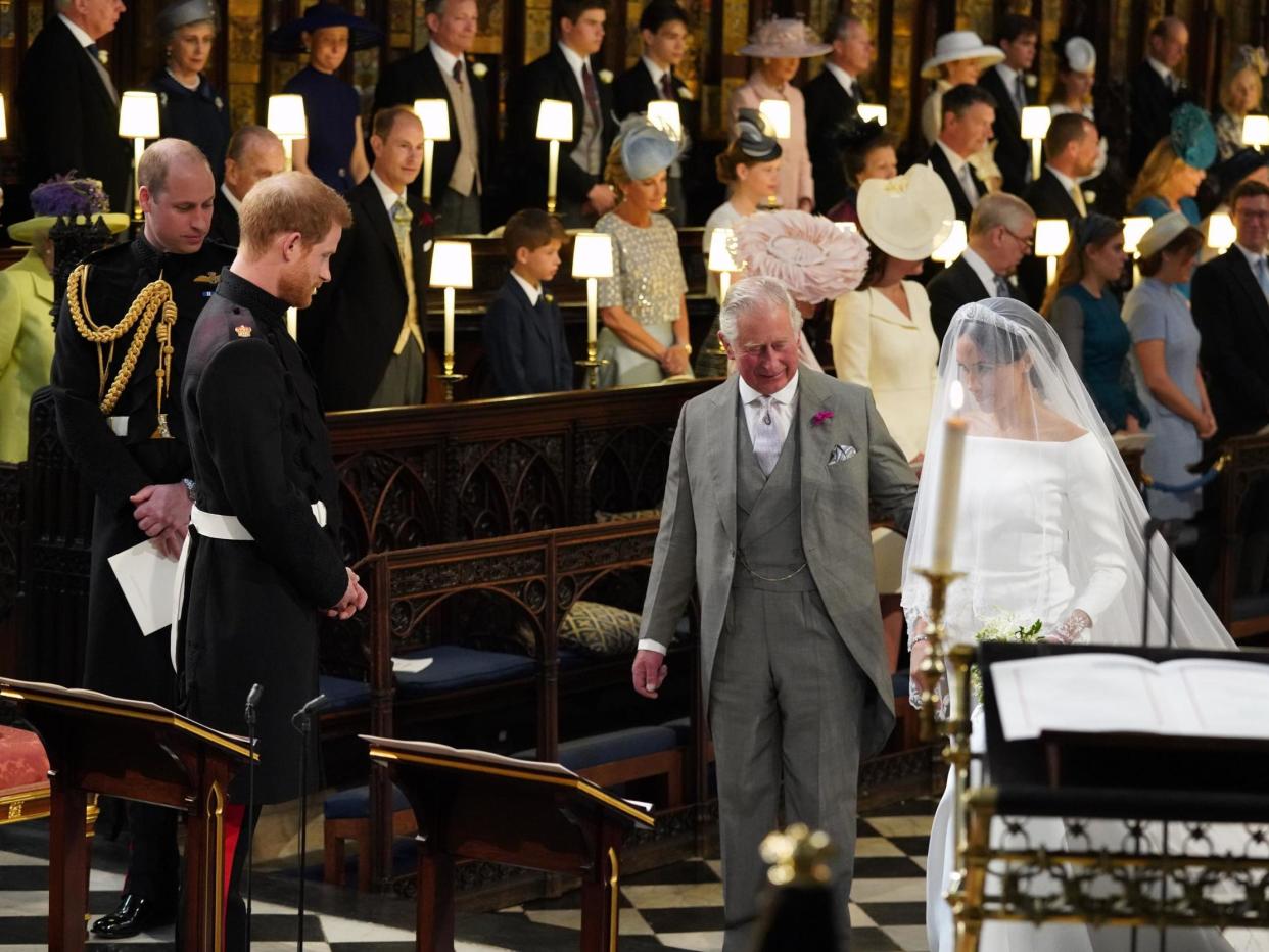 Meghan Markle is accompanied by Prince Charles down the aisle at St George's Chapel in Windsor Castle, 19 May 2018: JONATHAN BRADY/AFP via Getty Images