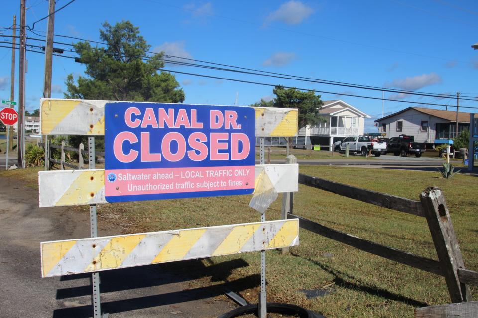 Parts of Canal Drive were still blocked off to traffic Saturday morning because of standing water left by Hurricane Ian's rains.