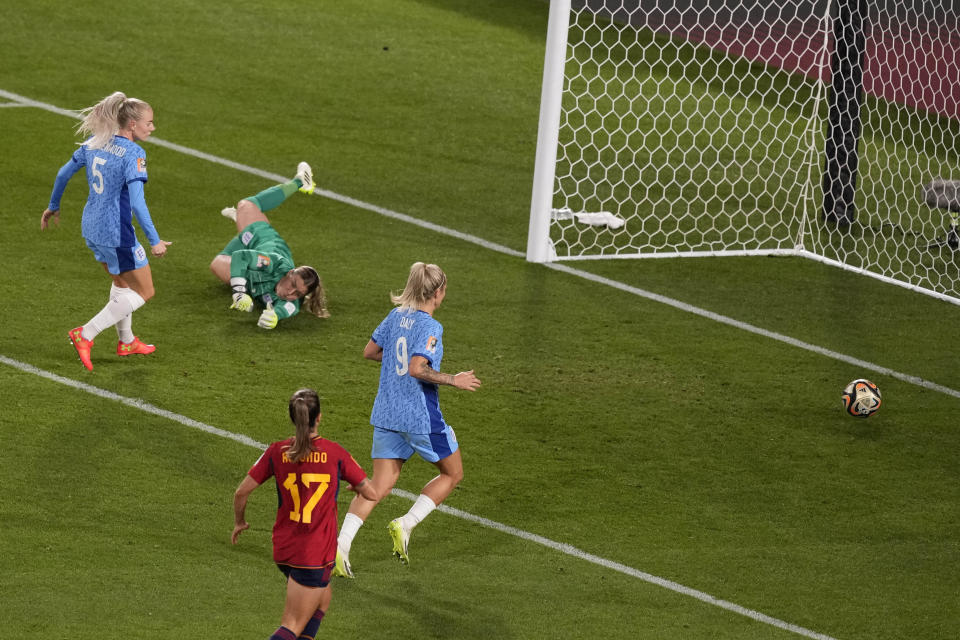 England's goalkeeper Mary Earps, second right, falls as she fails to stop a shot from Spain during the Women's World Cup soccer final between Spain and England at Stadium Australia in Sydney, Australia, Sunday, Aug. 20, 2023. (AP Photo/Mark Baker)