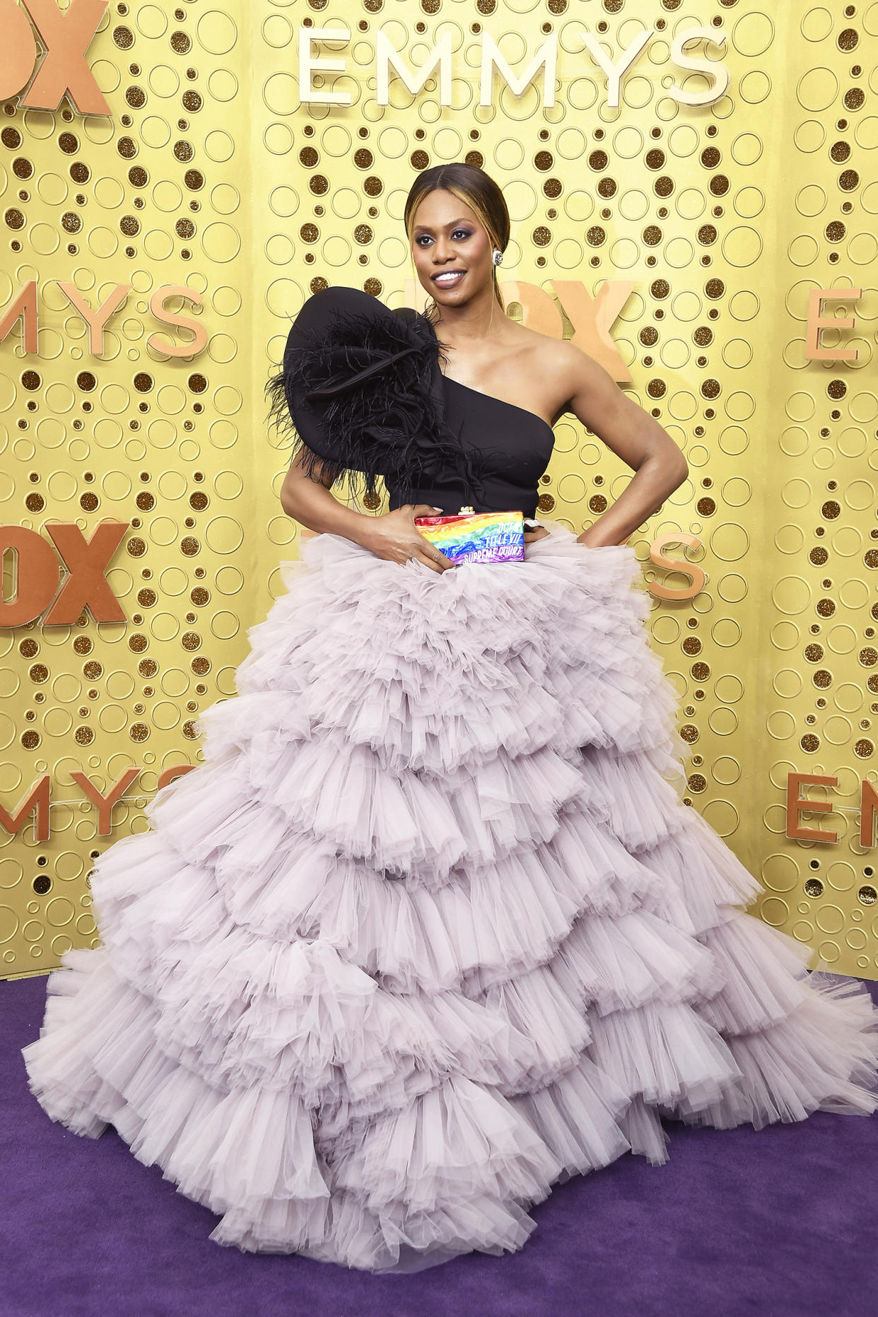 Laverne Cox wearing a dress on a yellow background (Frazer Harrison / Getty Images)