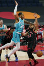 Charlotte Hornets forward P.J. Washington (25) loses the ball as he drives into Toronto Raptors guard Fred VanVleet (23) during the first half of an NBA basketball game Saturday, Jan. 16, 2021, in Tampa, Fla. (AP Photo/Chris O'Meara)